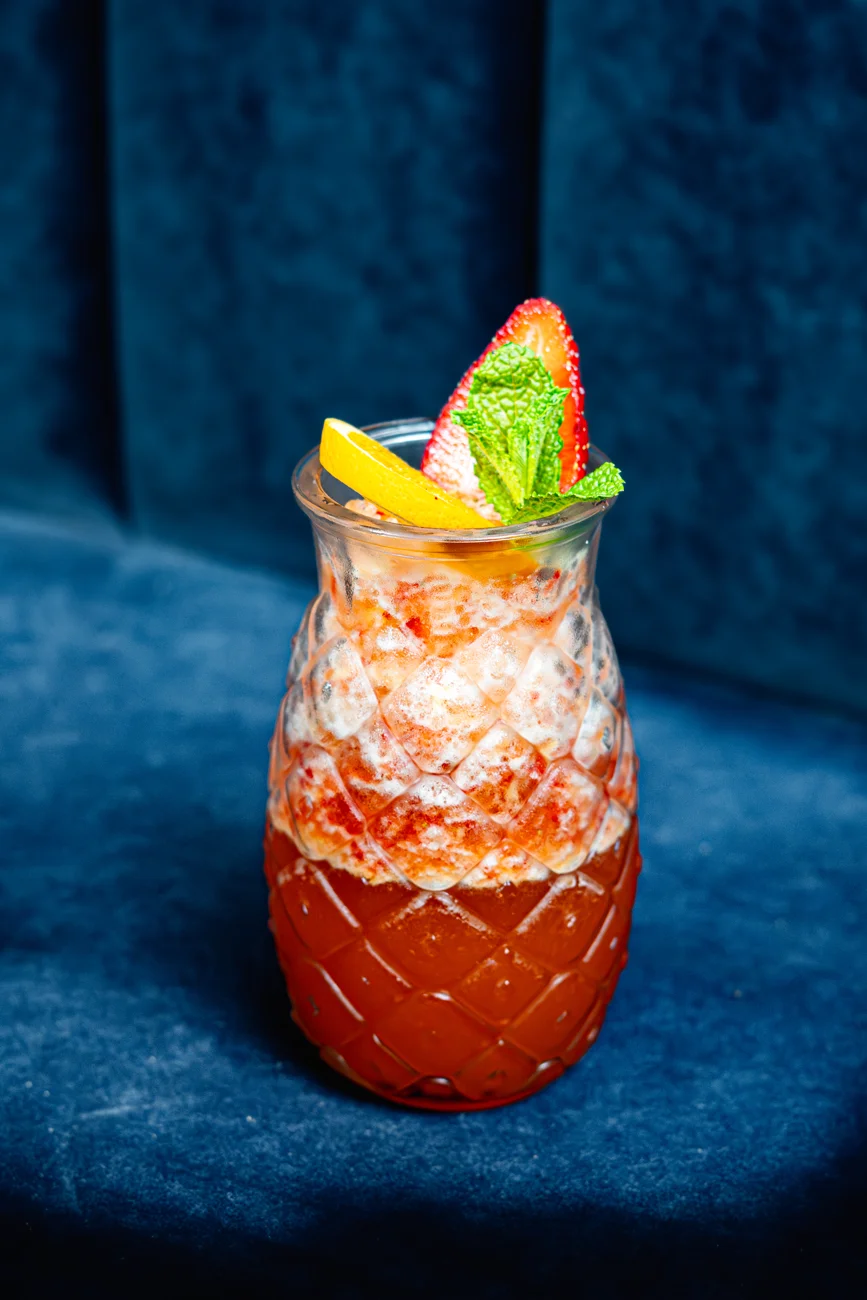 Iced fruit tea against blue velvet