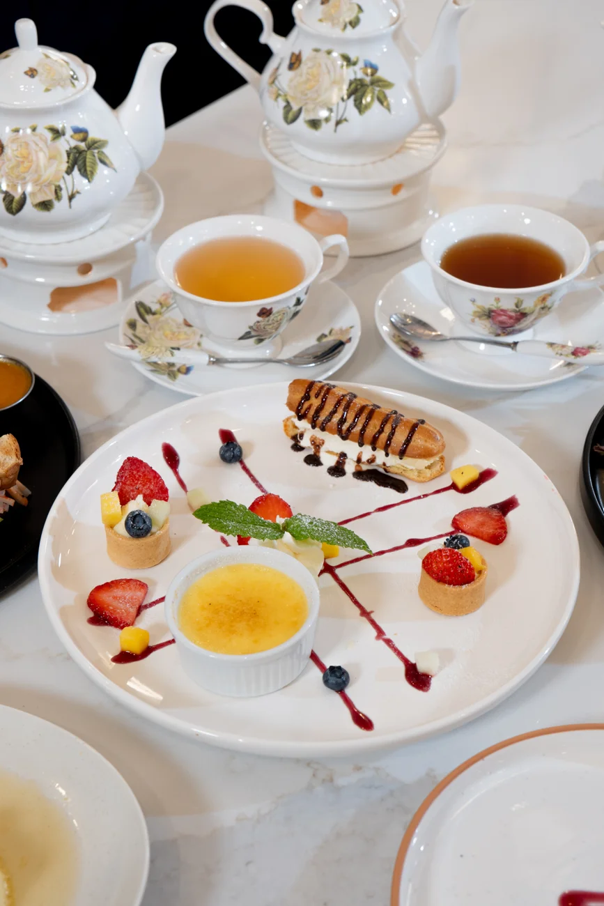 Afternoon tea with floral china and an assortment of delicate desserts